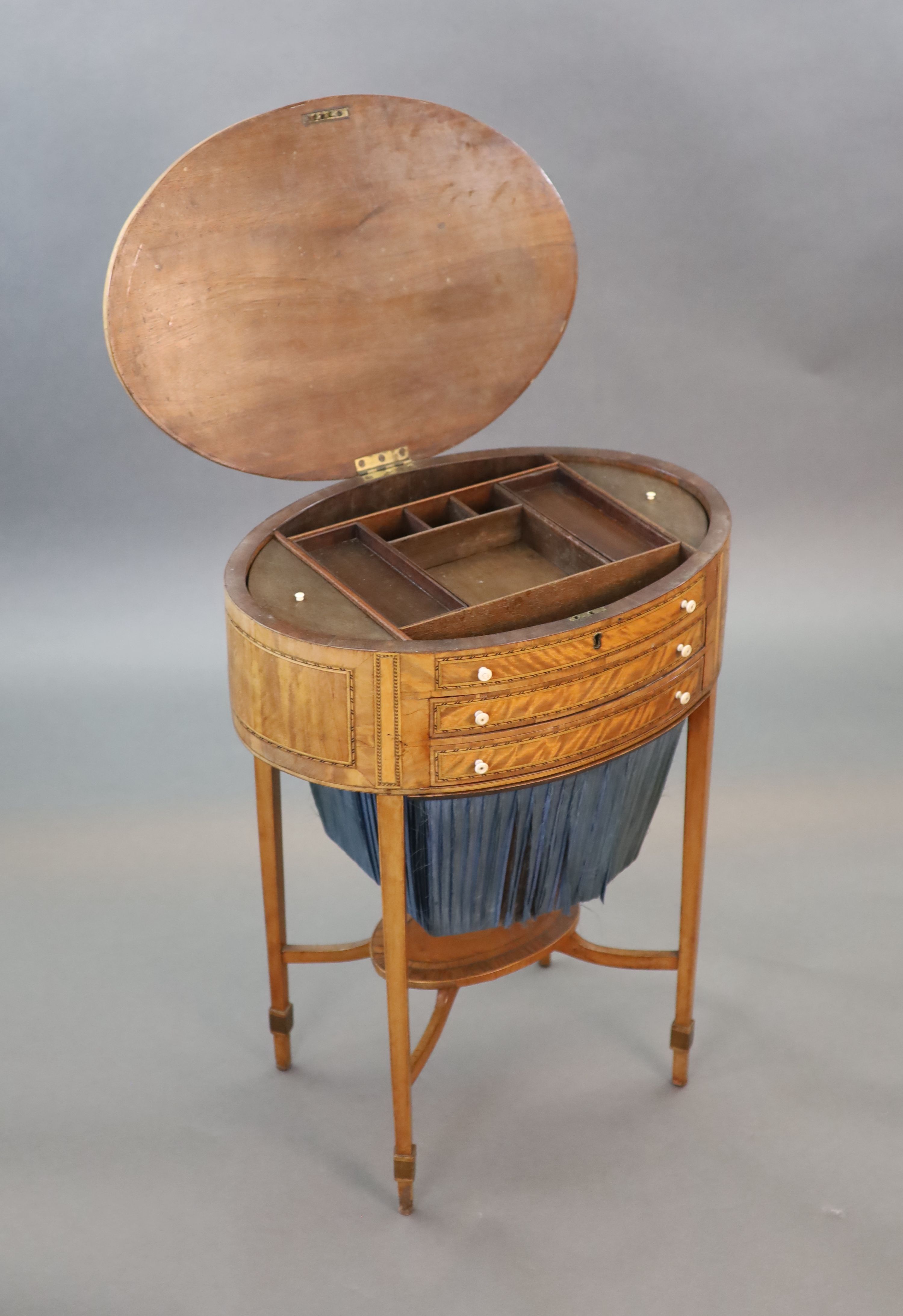 A George III rosewood banded satinwood oval work table, W.54.5cm D.39cm H.70cm